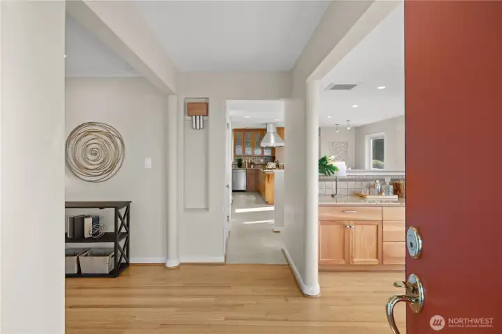 From the moment you step inside, you'll feel the warmth and welcome of this Mid-Century home, where sunlight pours in and newly refinished hardwood floors add rich character throughout.