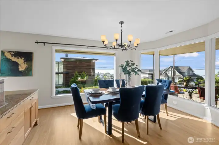 The main floor dining room with views of Puget Sound and the Olympic Mountains offers a dramatic and serene backdrop - especially during sunsets or stormy weather when the light plays over the water and peaks.