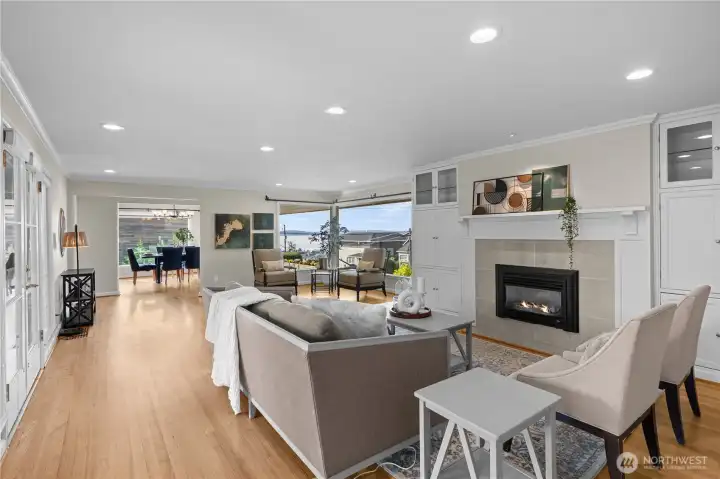 Main floor living room features a cozy gas fireplace and breathtaking panoramic views of Puget Sound and the Olympic Mountains. The interior of this turnkey home has been freshly painted and it's ready for the new owners to move right in!