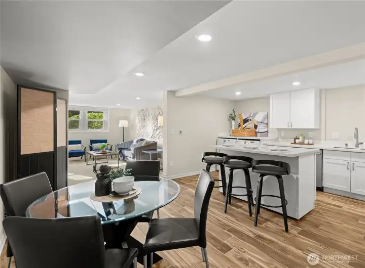 The lower-level kitchen with eating area and floating island features heated tile floors and stainless steel appliances.