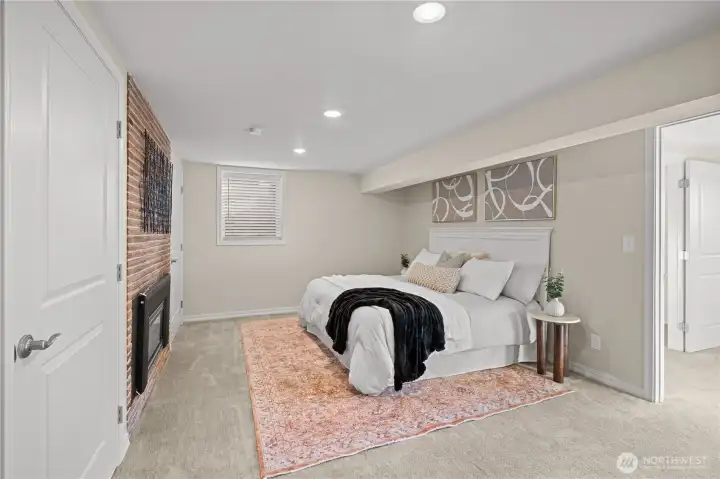 Primary bedroom with ensuite bath, dual closets and gas fireplace.