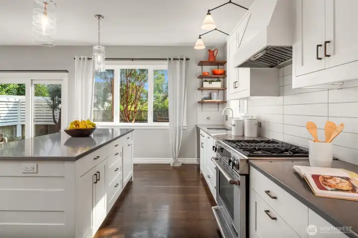 Jenn-Air gas range and custom hood will delight the home chef.