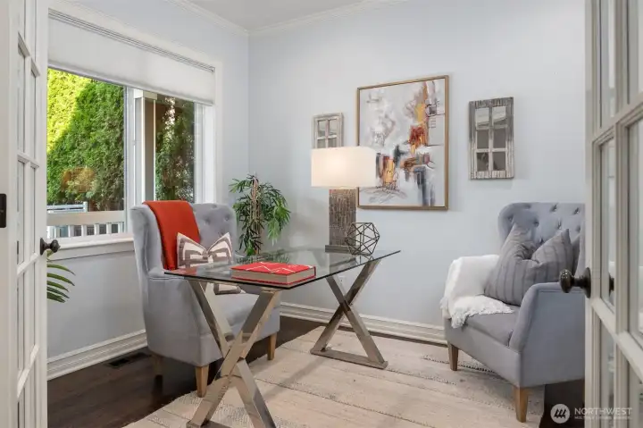 A bonus room on the main level with French doors and built in cabinetry and shelving for your office or crafts!