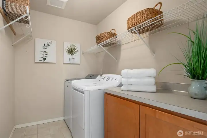 Second floor laundry room with plenty of storage and space to fold or hang up clothes.
