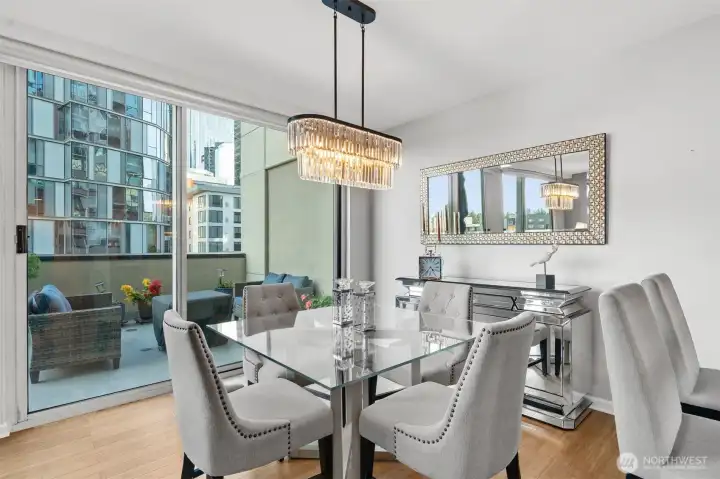 Dining area with contemporary lighting and open flow to terrace.