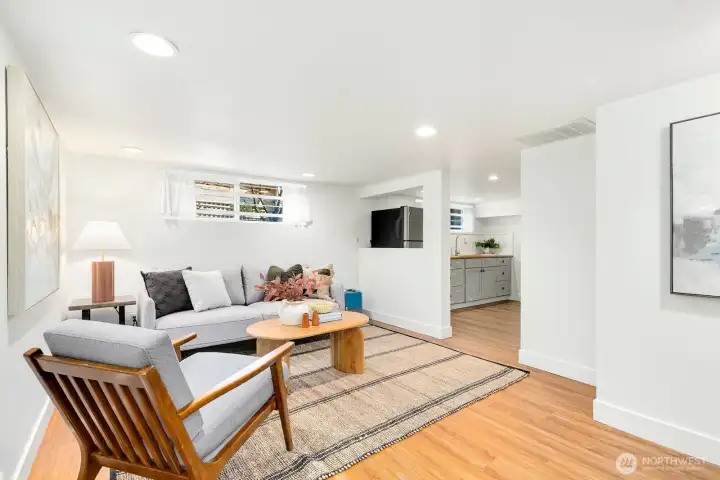 Head down to the lower level - this space could double as an ADU! For now, it's staged as a rec room. Great space for tv or game room!