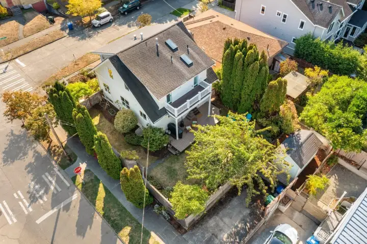 Note the corner lot and the parking pad you see below at the bottom of the photo. Between that and the driveway, it's nice to have two parking spots in such a prime location!