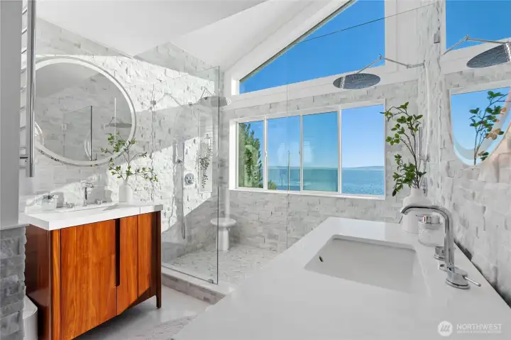 Relax under either of the rainfall shower heads while you overlook the Sound. This primary bath also features heated flooring, imported Turkish marble, heated towel bars, and anti fog mirrors.