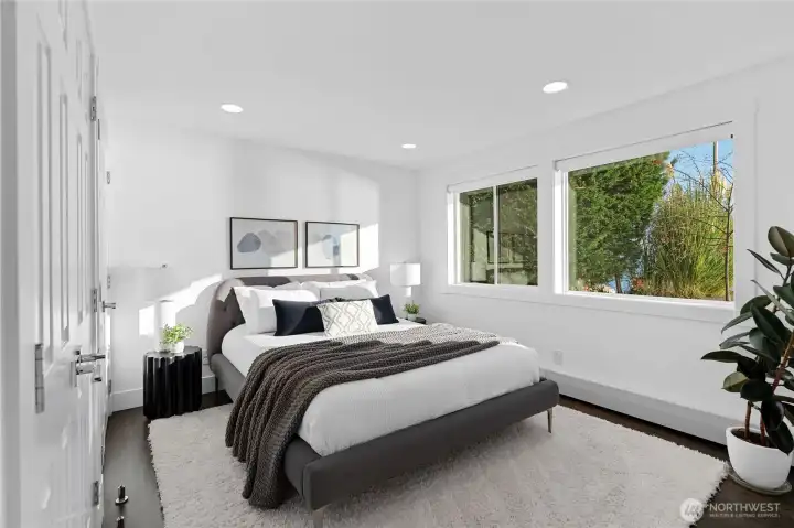 A second well sized bedroom downstairs provides ample space for guests