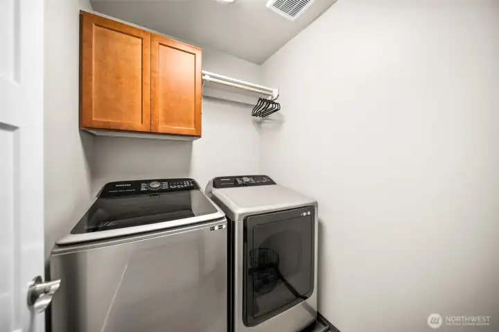 Laundry room conveniently located next to bedrooms.