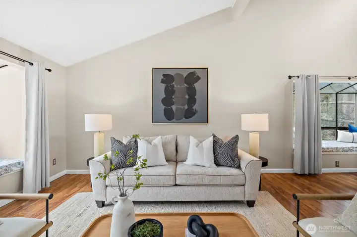 Living area with 2 window nooks, pellet stove and open to dining and kitchen