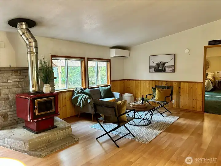 Close up of living room, ductless mini split, primary suite off to the right.