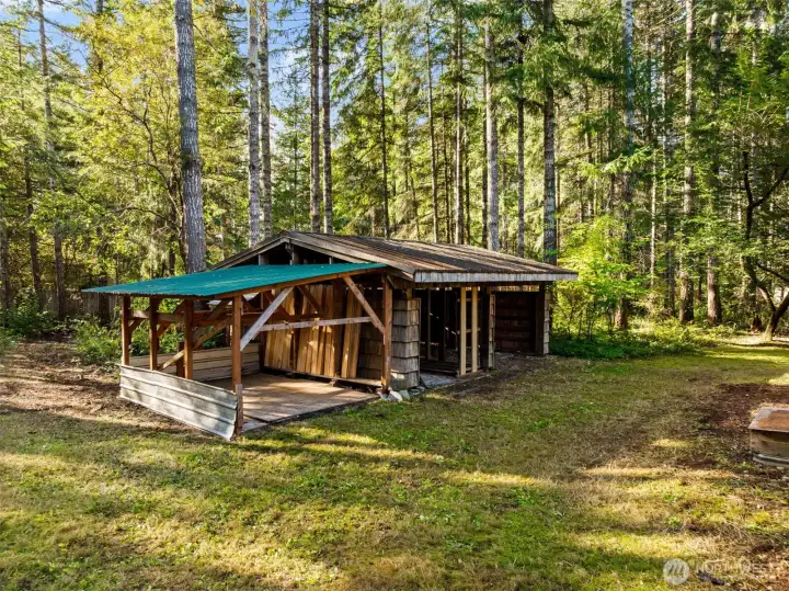 Wonderful woodshed with lean to for more covered Storage.