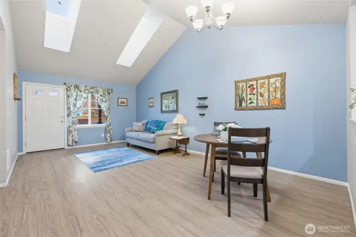 Main living room and dining area. Vinyl plank flooring.
