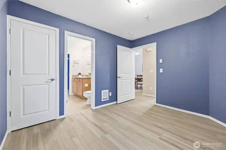 2nd bedroom with closet on left and door to bath.
