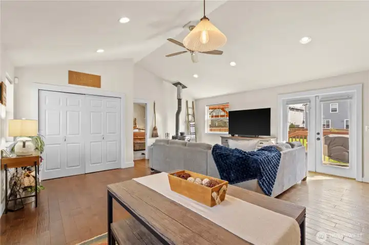 French doors open to a generous backyard with garden beds and newly refreshed landscaping, perfect for relaxing or entertaining.