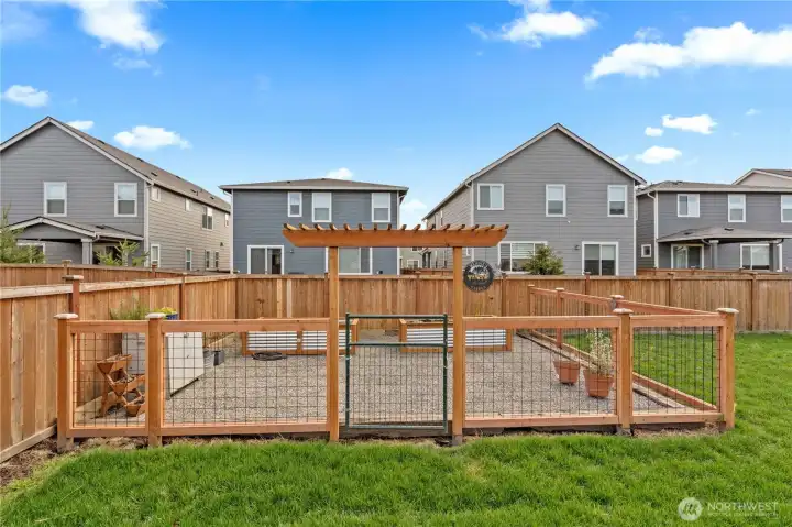Fenced in garden area with raised beds.