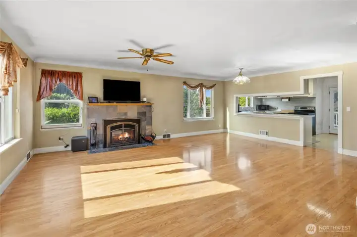 Living room features new gas fireplace with slate surround, look how much natural light flows in here. Original coved ceilings and large baseboard trim work.