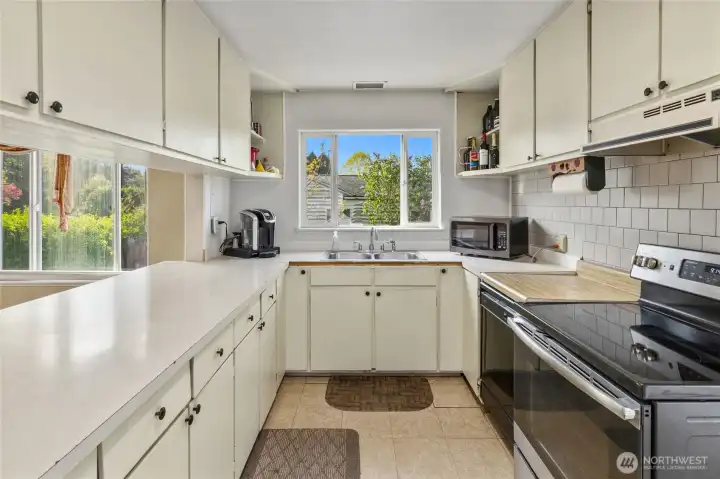 Plenty of counter space and cabinets in this partially updated kitchen, new tile backsplash and new appliances.
