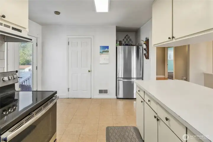 Perfect spot for high table or a small bistro table for more seating areas. Door leading down to basement.