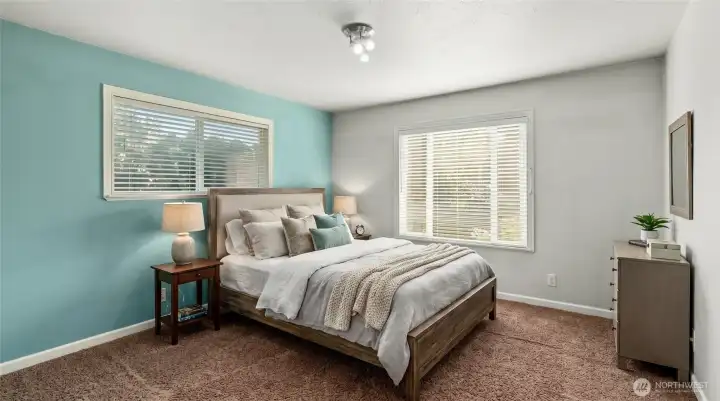 Primary bedroom on main floor, staged. New paint, windows and light fixture.