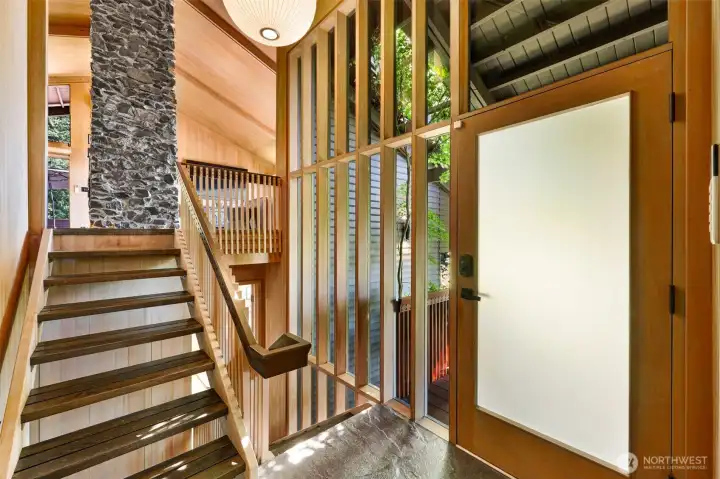 Entryway with airy, open-riser stairs and oversized Nelson bubble lamp. Entryway with airy, open-riser stairs and oversized Nelson bubble lamp.