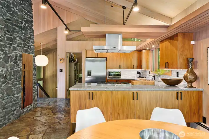 Kitchen and dining rooms with office in the background. Kitchen and dining rooms with office in the background.