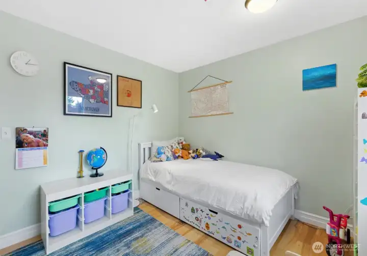 Bedroom with light wood floors, soft neutral tones