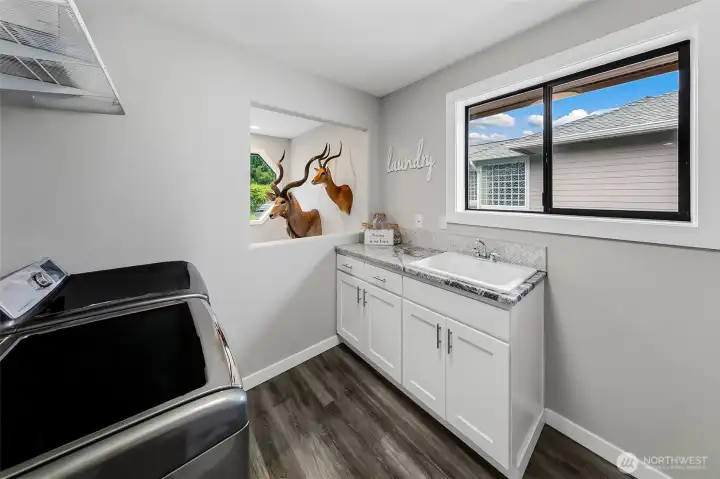 Large Laundry area with storage & sink, with open to below. Large Laundry area with storage & sink, with open to below.