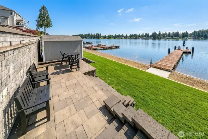 Lower level w/pavers, and shed w/power leading to yard & beach area Lower level w/pavers, and shed w/power leading to yard & beach area