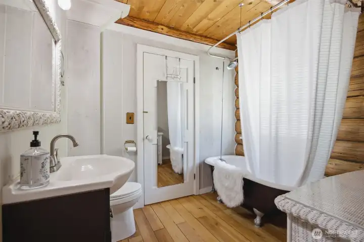 The home's character continues into the beautifully appointed main floor bath, where a classic clawfoot soaking tub provides the perfect place to unwind. The home's character continues into the beautifully appointed main floor bath, where a classic clawfoot soaking tub provides the perfect place to unwind.