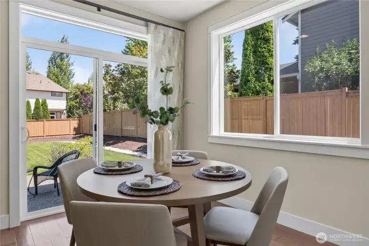 Sunny informal breakfast nook area with a slider to the backyard.