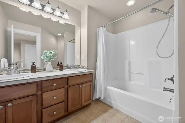 Upstairs guest bath with dual sinks.