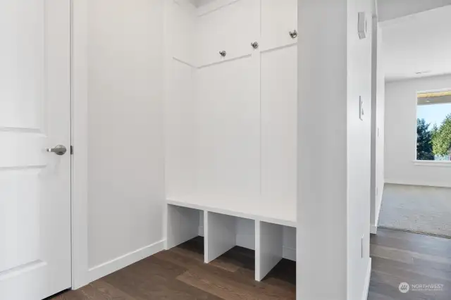 Mudroom bench built in from garage access - builder included upgrade! Hooks above, cubbies below, extra storage and organization.  Man Door Upgrade included from garage to rear yard!