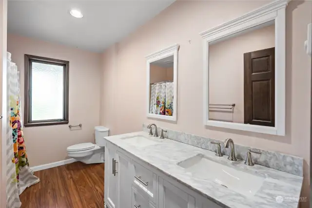 Full guest bathroom with updated flooring, double sink vanity and granite counters.  Centrally located and spacious.