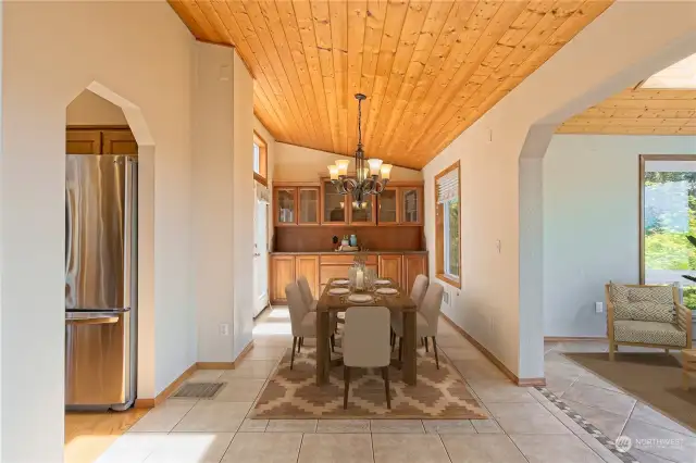 Dining room is adjacent to the kitchen and sunroom solarium.  French doors open to an additional outdoor dining deck, and the beautiful solid wood built in hutch expands your entertaining displays and storage.