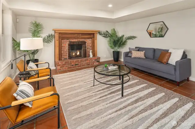 Sitting area off the primary bedroom. Wood-burning fireplace and loads of windows.