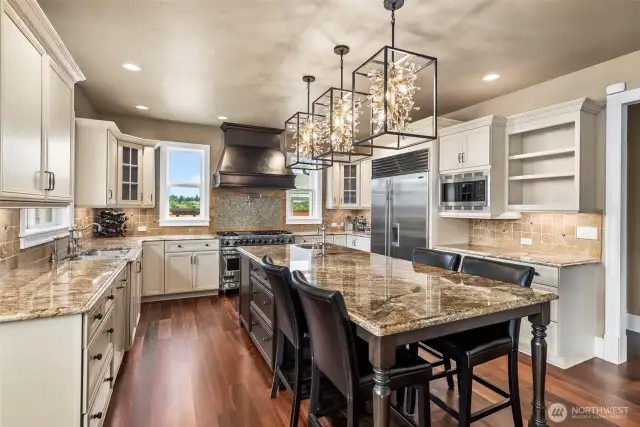 This gorgeous kitchen includes an immense island with a separate sink, extra high custom cabinets, high-end S/S appliances, including a professional Viking range & Subzero Refrigerator. Moreover, a window with a priceless view is placed by the sink.
