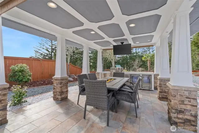 Step into an entertainer’s dream with stunning outdoor kitchen, nestled beneath a grand gazebo designed for seamless outdoor entertainment & offers both shelter and style. The expansive cooking area is equipped with top-of-the-line appliances, perfect for preparing meals while enjoying the beauty of your surroundings. As you enjoy the stunning outdoor kitchen and gazebo, you can easily keep an eye on the little ones as they play freely in their own magical Playset space. The play area, designed for fun, is nestled into the landscape.