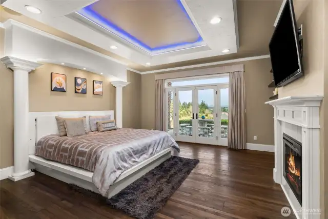 This primary suite is a retreat in every sense of the word, with crown and coved molding enhancing its elegant feel. A cozy fireplace adds warmth, while automatic curtains offer convenience at the touch of a button. The French doors open wide to the extraordinary deck, creating an effortless flow between indoor luxury and outdoor tranquility. Whether you're enjoying a quiet evening around the fire or watching the sunset dip behind the mountains, the stunning views of Mt. Rainier provide the perfect backdrop for your moments of peace and reflection. This beautifully updated, custom home seamlessly brings nature’s majesty right to your doorstep.