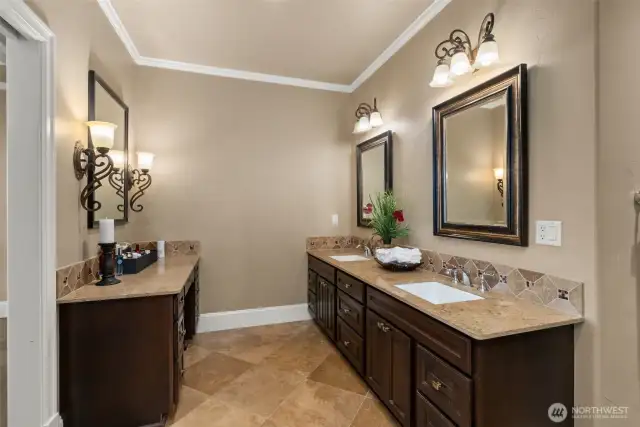 This primary bath is nothing extraordinary. With its luxurious crown molding, beautiful tile heated flooring, and stunning walk-in shower, it creates an atmosphere of sophistication and serenity. Dual vanities offer generous storage, and the massive walk-in closet ensures you have room for all your essentials. And, with a large window by the Jacuzzi tub framing the majestic view, you can relax in style while taking in the breathtaking landscape. It’s a space where every detail contributes to an unforgettable experience—get your spa day scheduled, because this master bath is your personal retreat.