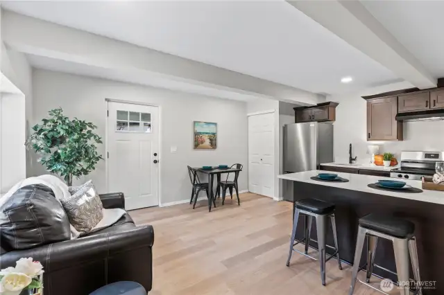 C/Lower Floor: Great Room: Living, Dining, Kitchen w/Laminate Floors, Recessed Lighting and Laundry Closet.
