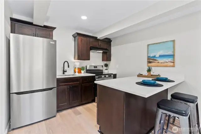 C/Lower Floor: This is the 3rd Kitchen in this unique home! Kitchen w/Fridge and Range. Island easily fits 2 barstools.