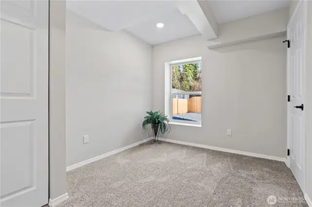 C/Lower Floor: Bedroom w/Closet and Window overlooking backyard. New Carpet, Millwork, Doors, Hardware throughout!