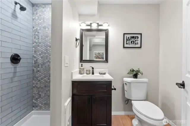 C/Lower Floor: Perfectly Sized Bath is the 4th Bathroom in this home! Laminate Floors and Custom Tiled Shower, New Vanity and Fixtures. (Bath #4)