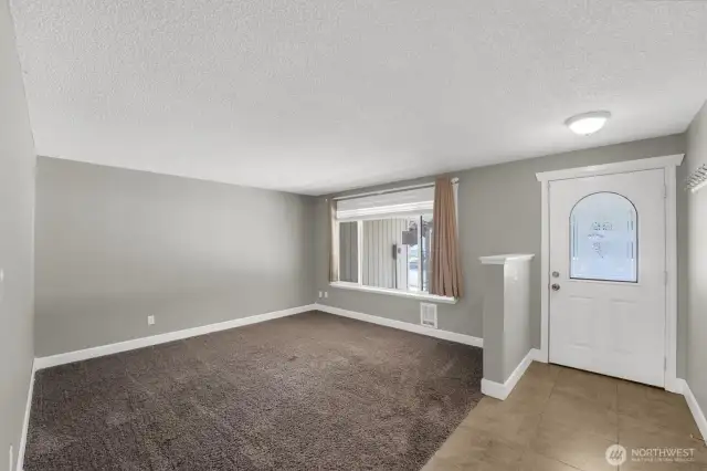 The living room and front entry door