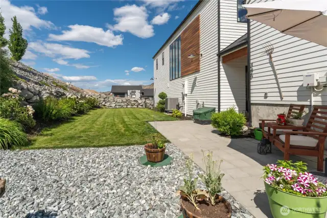 cozy backyard with mature landscaping and patio.