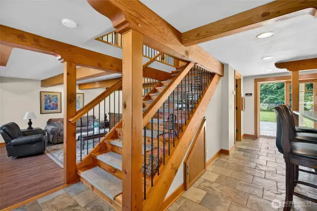 The focal point stairs showcase the reclaimed Douglas Fir wood accented with modern wrought iron spindles give this home character.