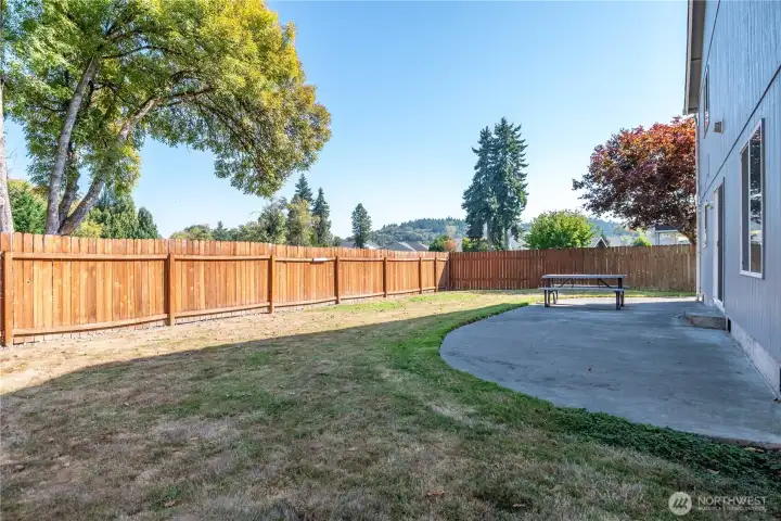 Fully fenced backyard with patio