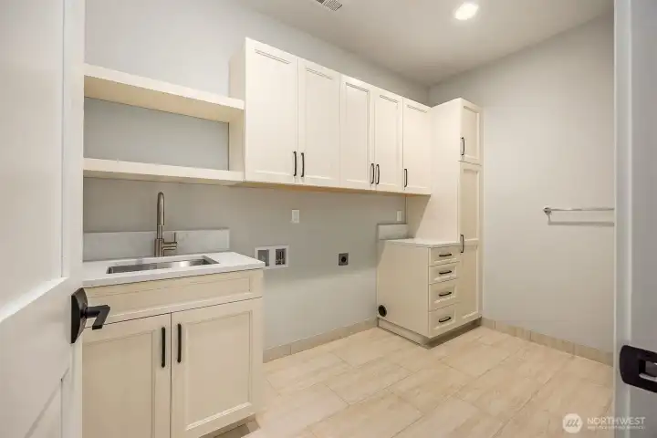 Laundry room on second level attached to primary suite - how convenient!